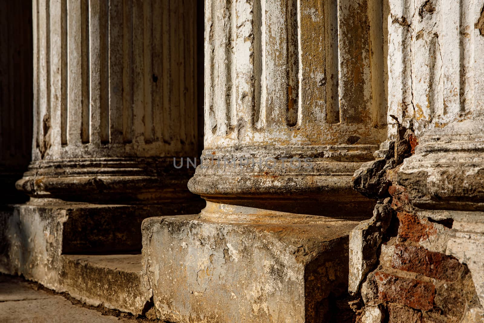 Ruined old columns with base and flute. Sunlight. by 9parusnikov