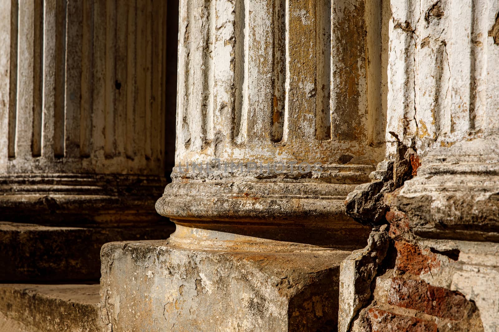 Ruined old columns with base and flute. Sunlight. by 9parusnikov