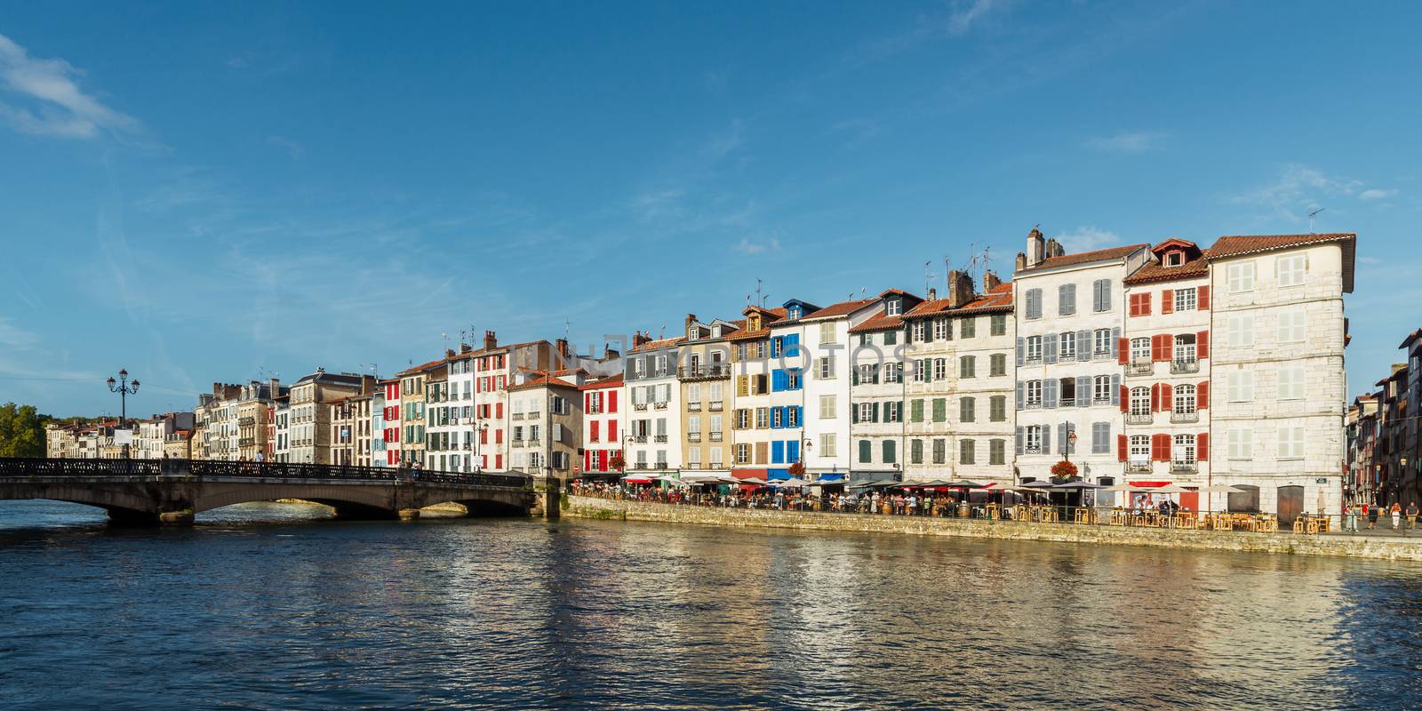Colorful building facades along the Nive river, in Bayonne, France