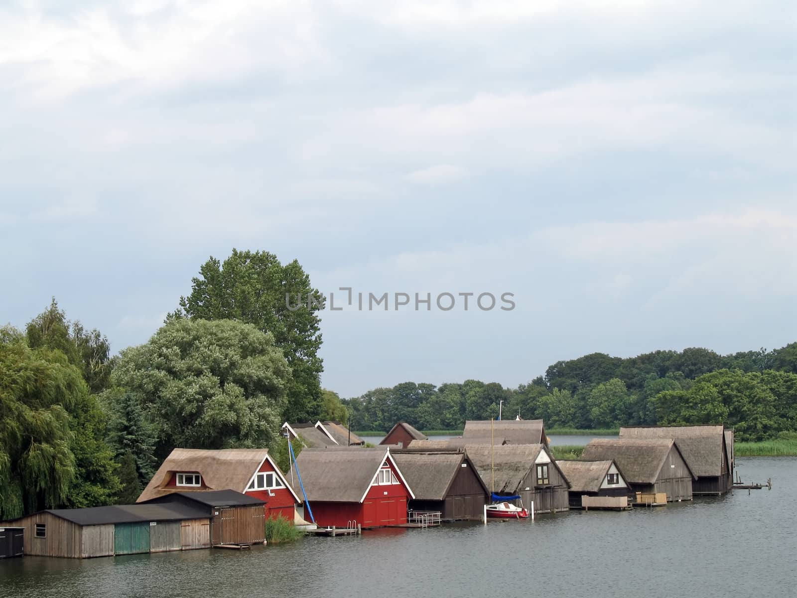 Lake Mueritz with thatched boathouses in Mecklenburg-Western Pomerania, Germany.