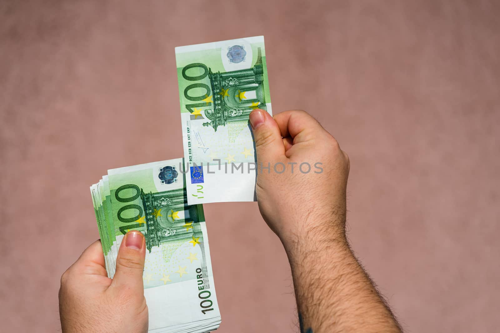 Hand holding and showing euro money or giving money. World money concept, 100 EURO banknotes EUR currency isolated. Concept of rich business people, saving or spending money.