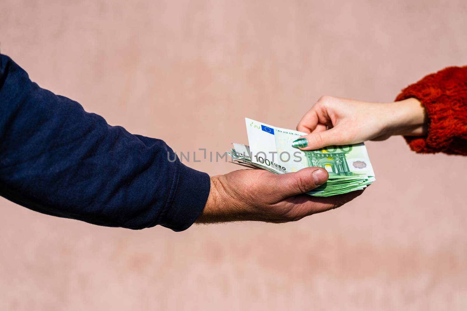 Hand giving money like bribe or tips or salary isolated, hard worked hand taking euro banknotes. Currency transfer and reward for hard work.