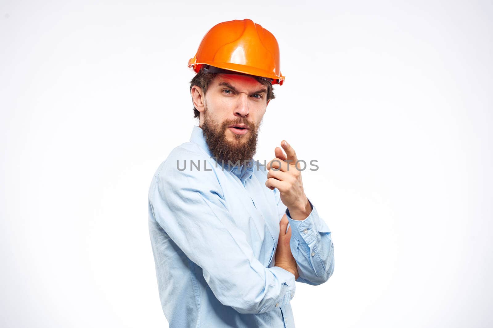 Engineers shirt orange hard hat construction lifestyle emotions cropped view light background. High quality photo