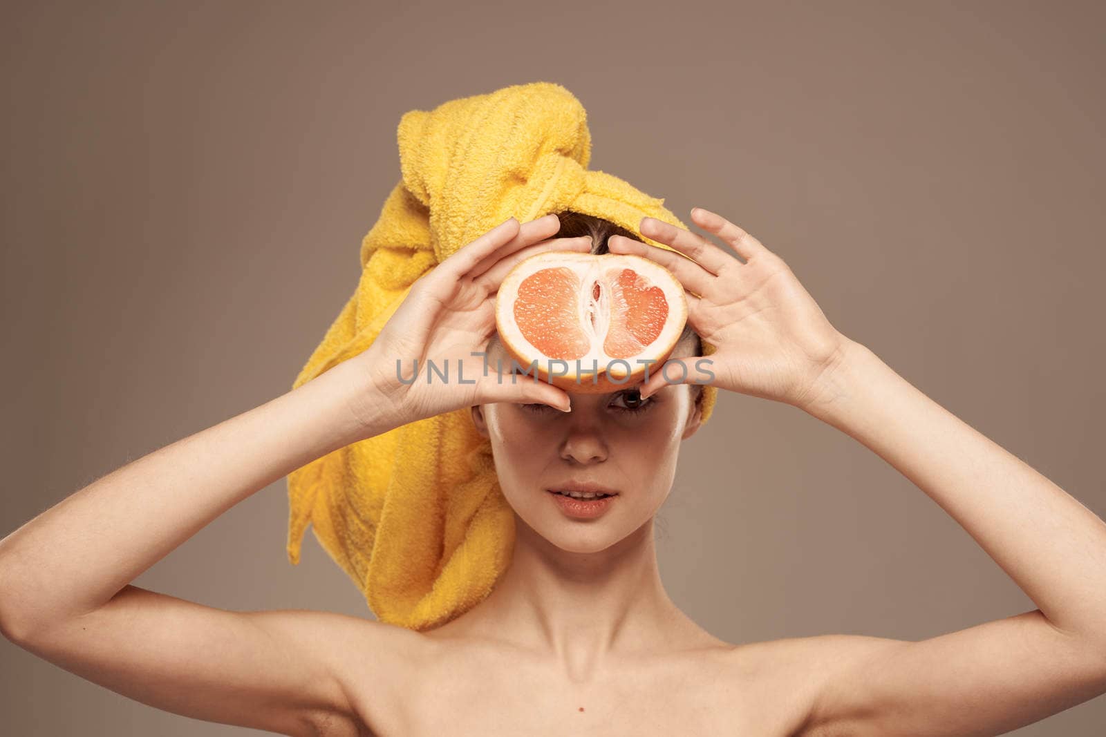 woman with grapefruit in hands naked shoulders and skin care vitamins by SHOTPRIME