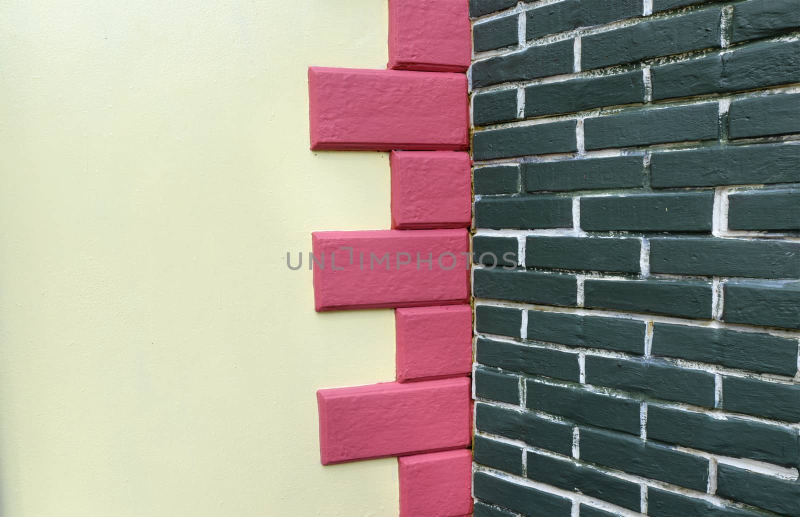 White wall background decorated with pink concrete And green bri by hellogiant
