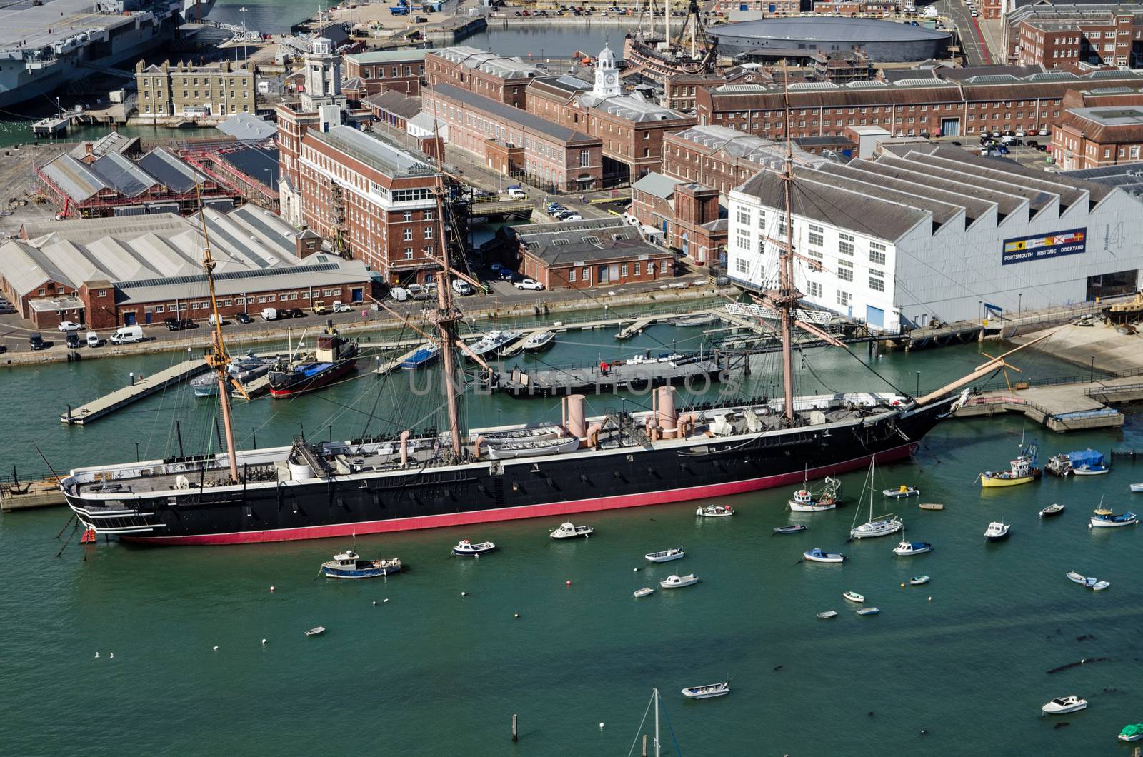 View from a high position looking down on HMS Warrior, the first iron hulled warship in the Royal Navy, on display in Portsmouth Historic Dockyard on a sunny day in Hampshire.