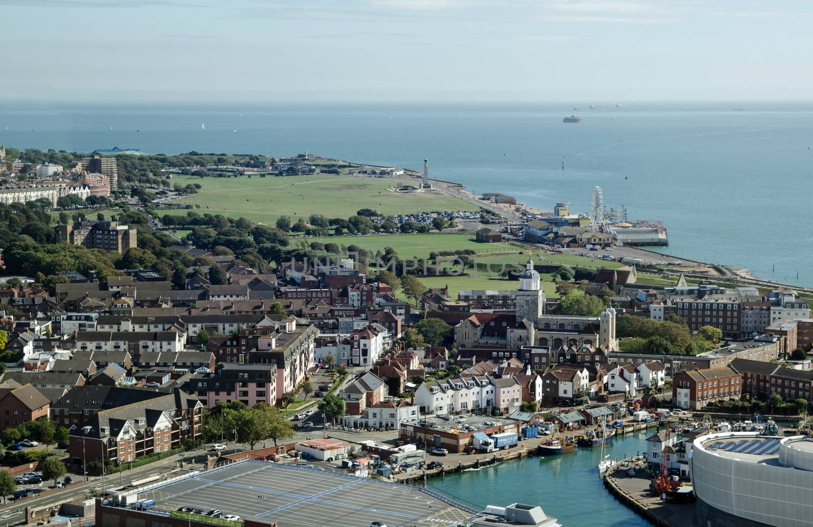 Aerial view across Portsmouth with the historic cathedral, and beyond to Southsea Common with the funfair and beach.