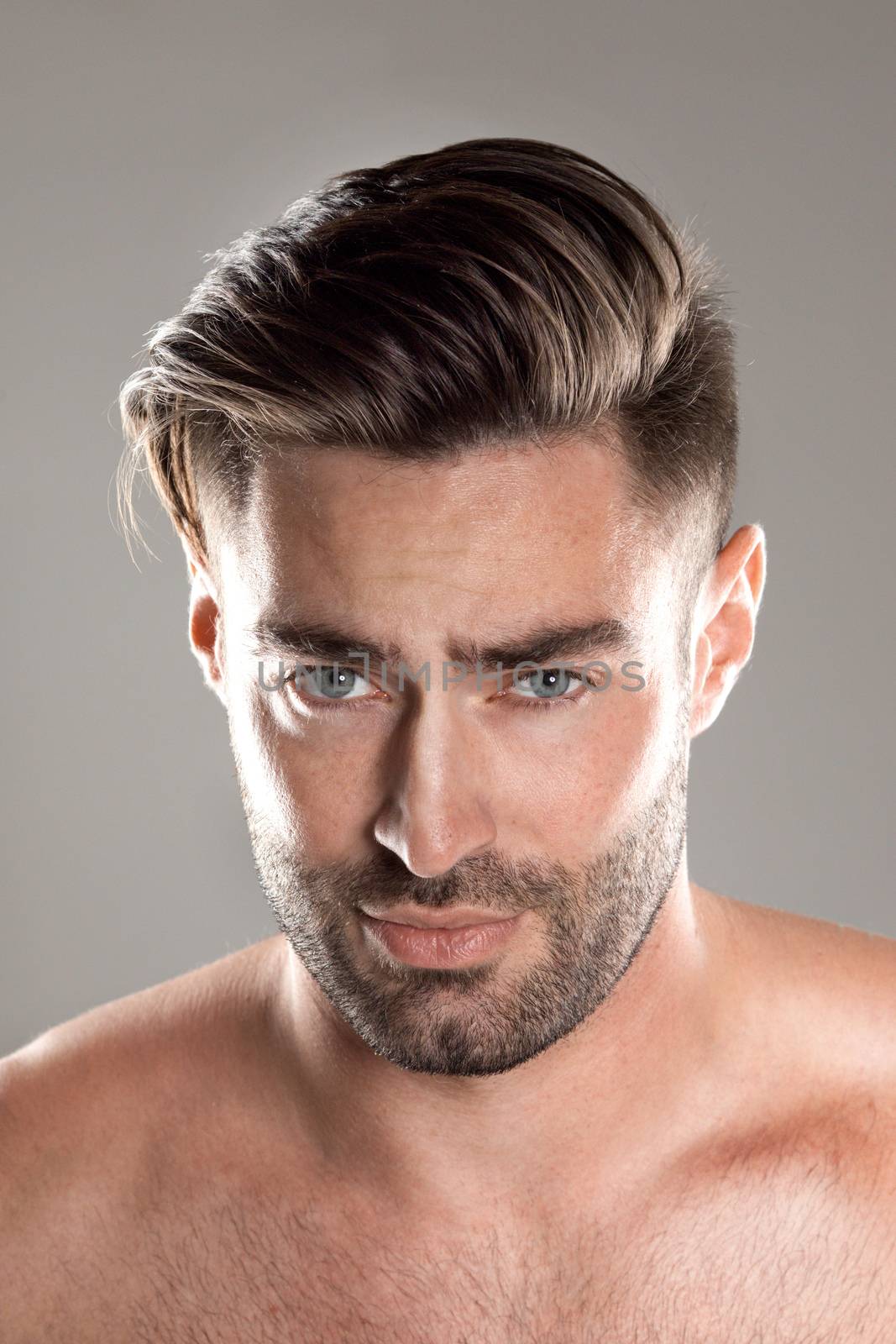 Closeup portrait of a beautiful male model, caucasian man with dark hair and gray eyes