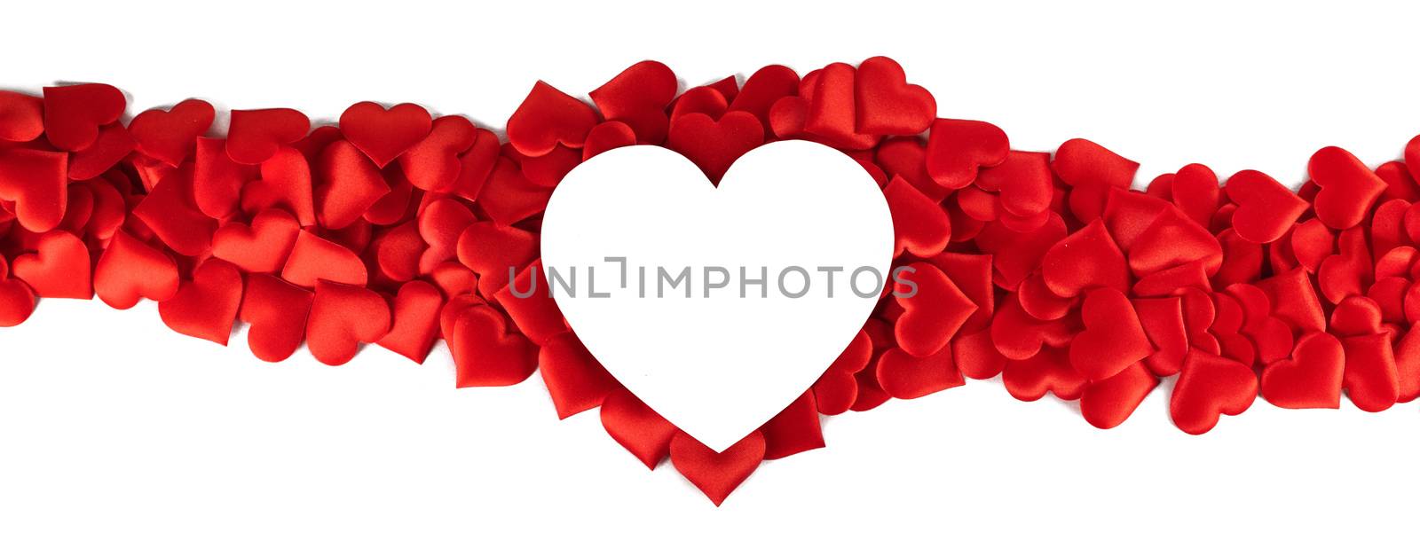 Valentine's day many red silk hearts and white heart shaped card isolated on white background, love concept
