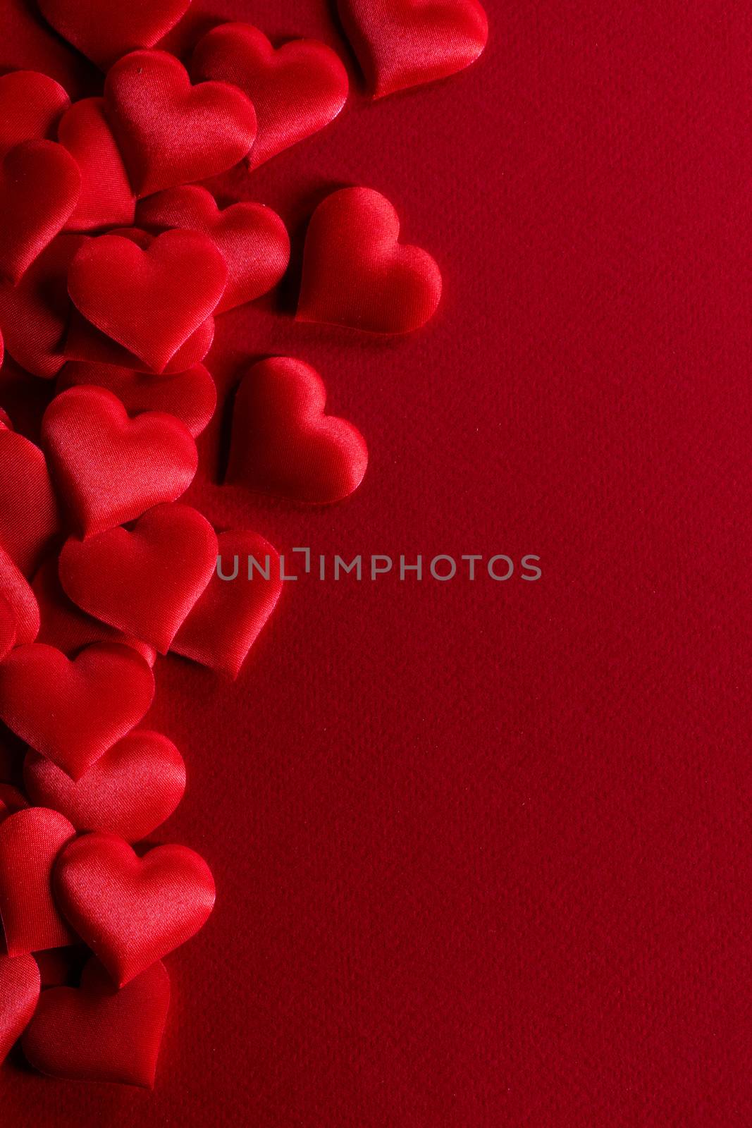 Valentine's day many red silk hearts background , border frame on red with copy space, love concept