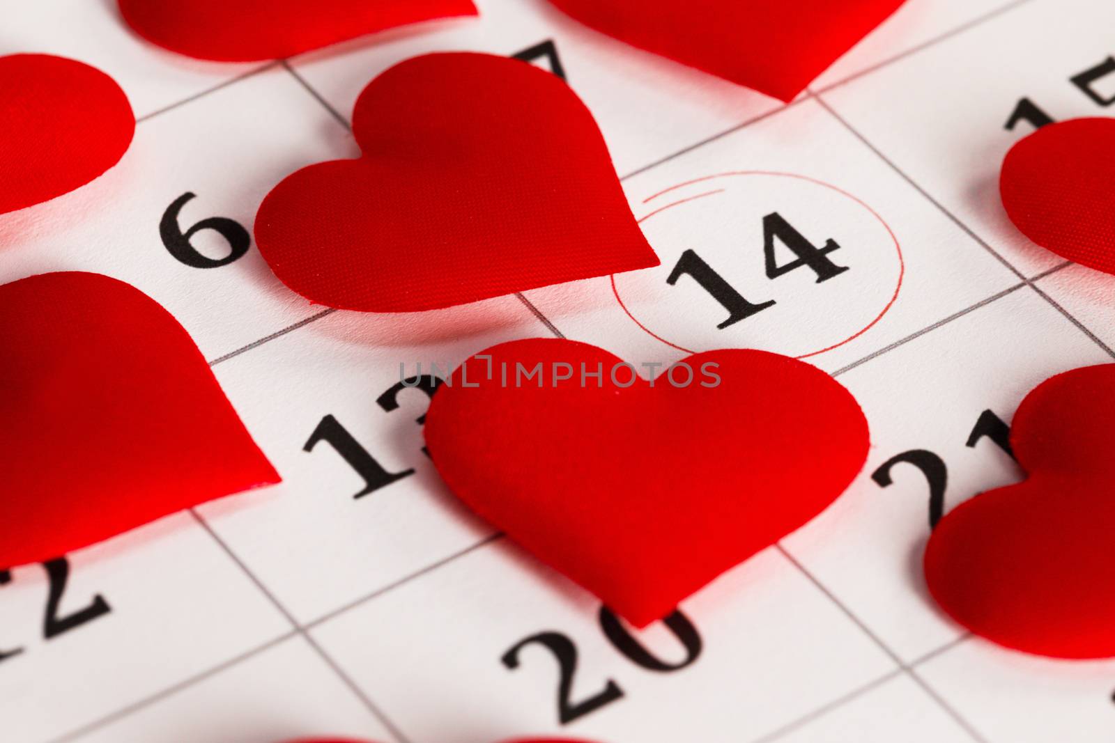 Valentine's day red silk hearts on calendar with 14 february date background, love, celebration concept