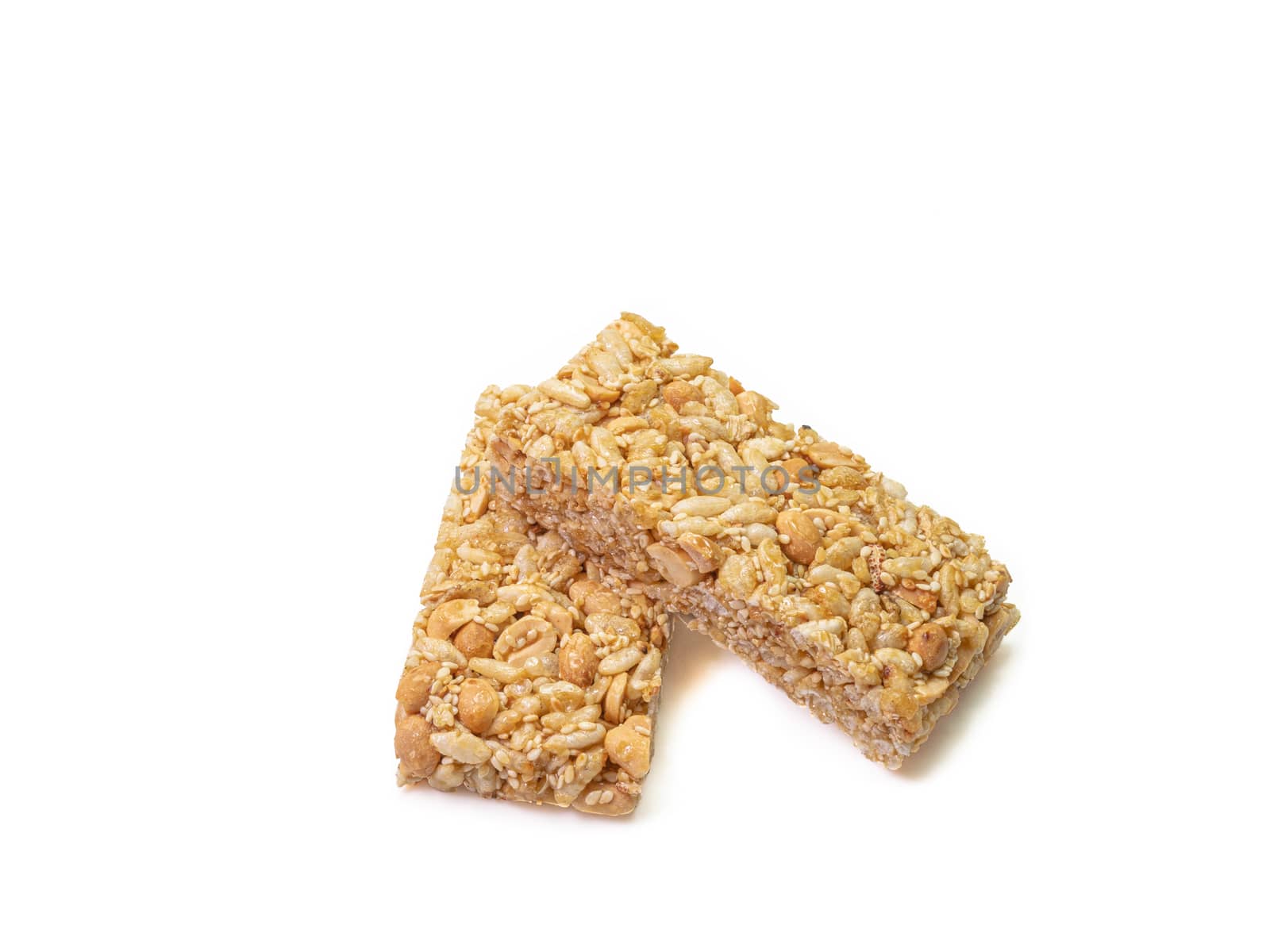 The close up of homemade Thai sweet cereal bar candy on white background, traditional muesli food in thailand.