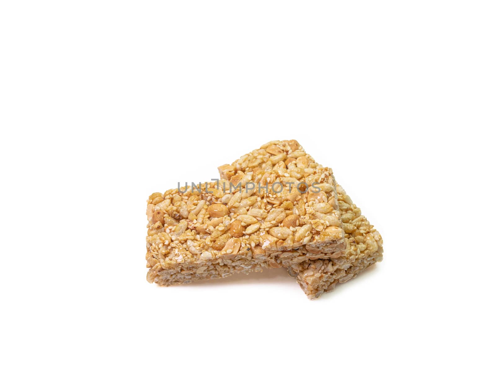 The close up of homemade Thai sweet cereal bar candy on white background, traditional muesli food in thailand.