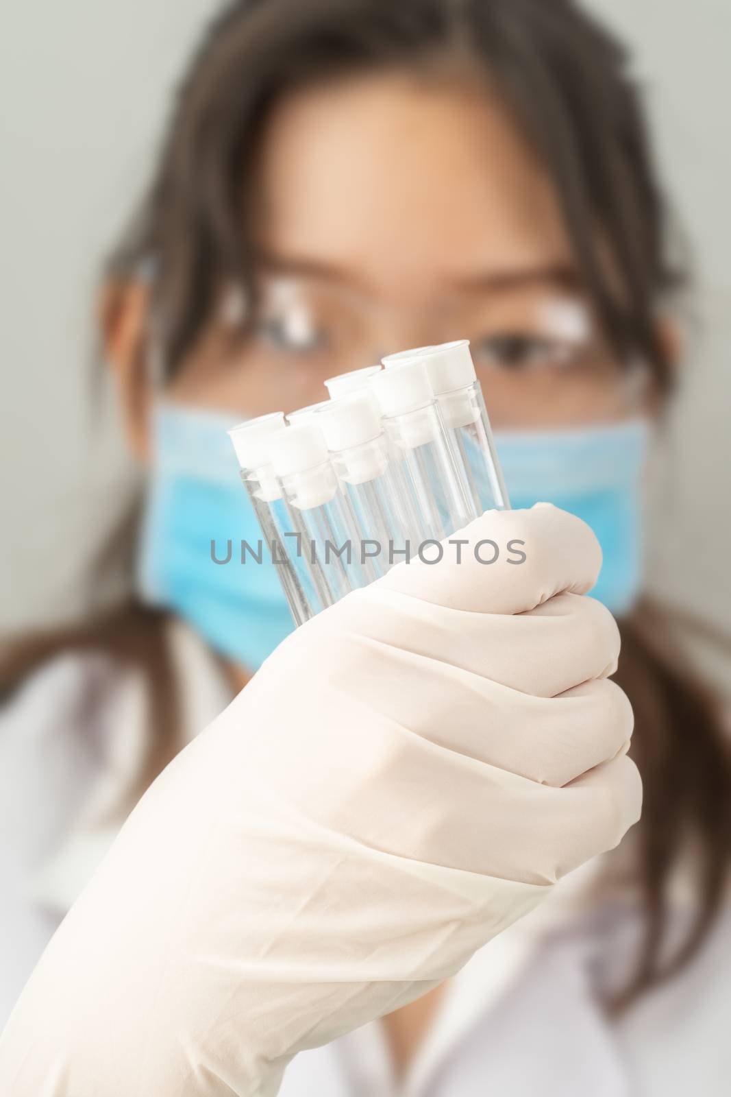 Scientist analyzing holding test tube in laboratory by stoonn