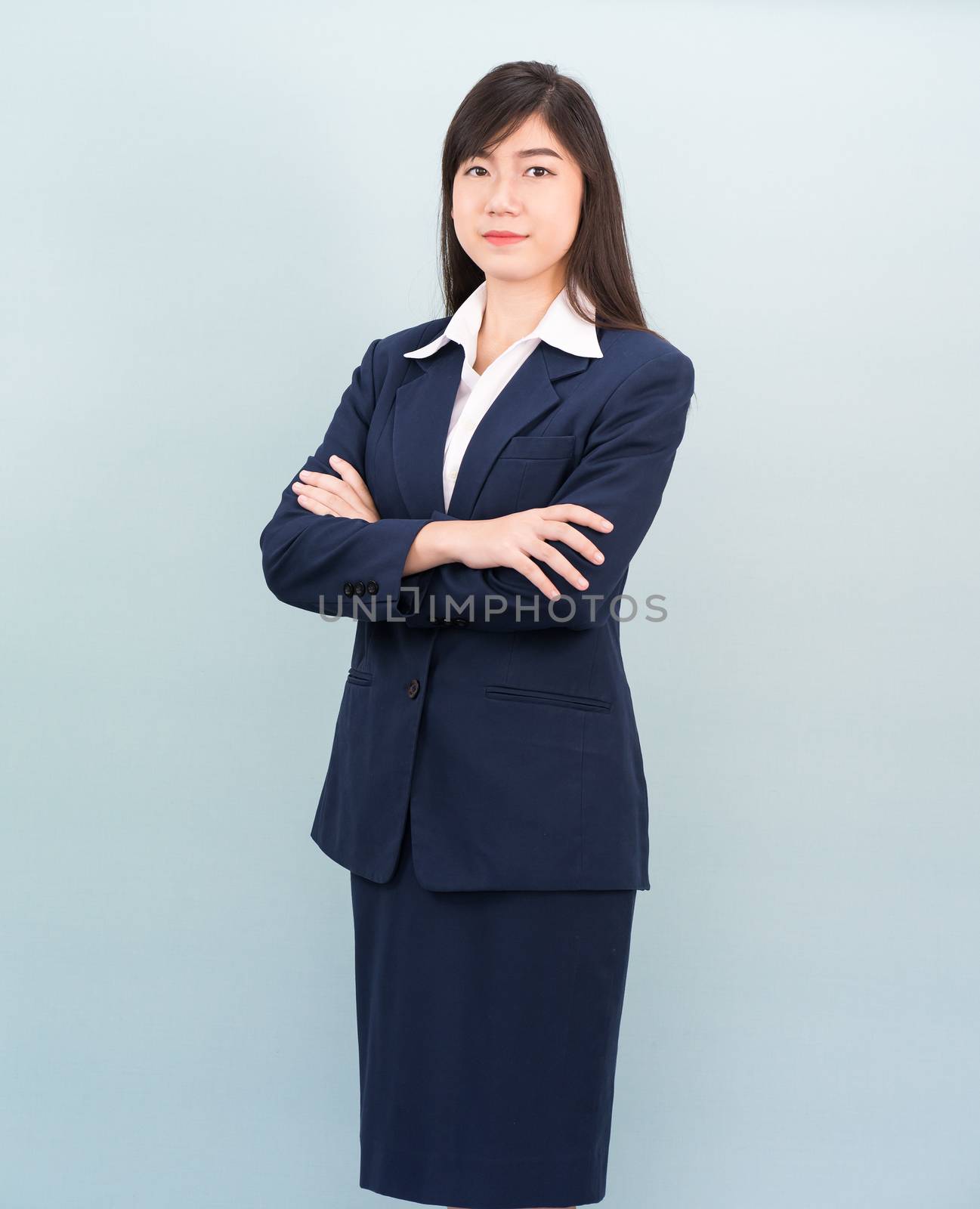 Teenage girl long hair is standing with her arms crossed by stoonn