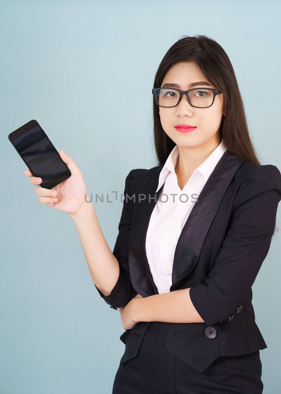 Young women in suit holding her smartphone by stoonn