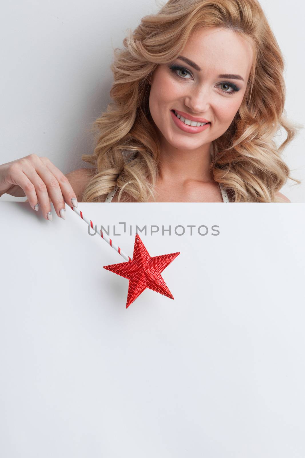 Fairy woman with magic wand with star pointing at white background with copy space for text