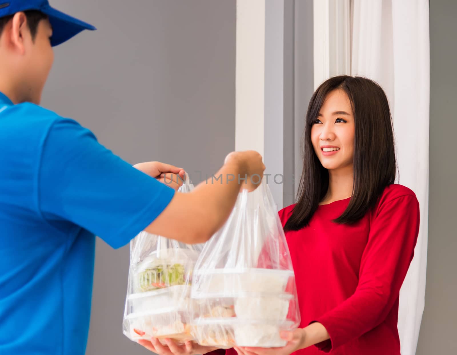 Delivery man making grocery service giving rice food boxes plast by Sorapop