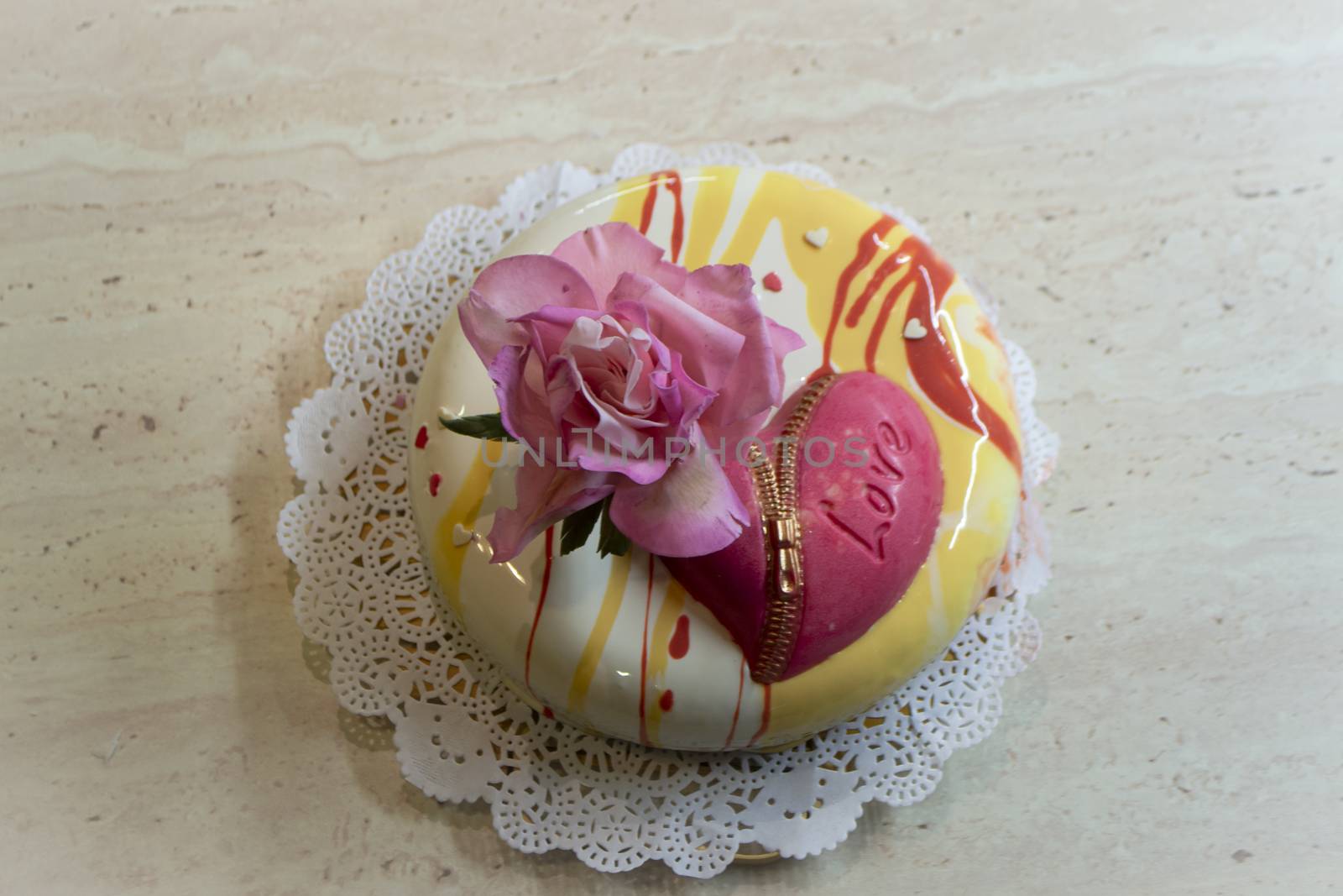 mousse cake with heart of chocolate decorated with edible rose. Fondant flowerSt. Valentine's Day