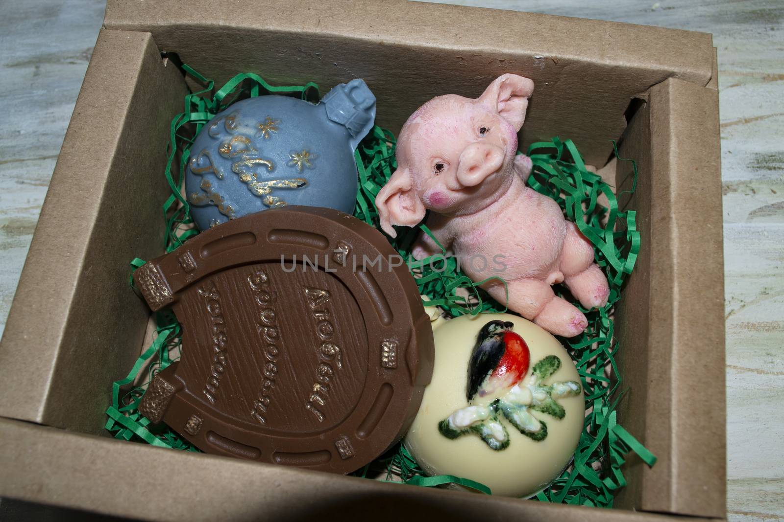 Chocolate toys in box on a wooden background Christmas concept of a New Year's toy.