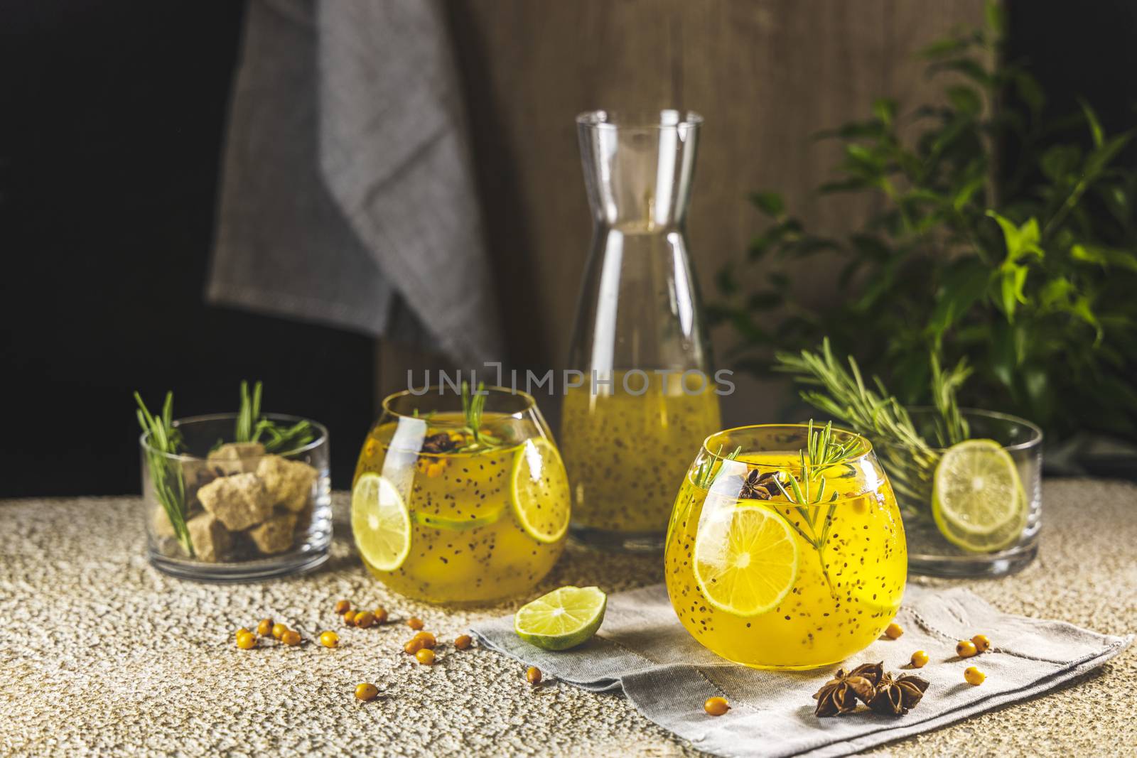 Sea buckthorn iced tea or lemonade with lime, rosemary, star ani by ArtSvitlyna