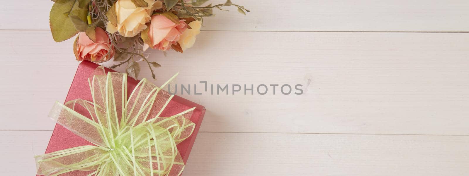 Beautiful flower and gift box on wooden background with romantic, presents for mother day or valentine day with pastel tone, nature for decoration on desk, holiday concept, banner website. by nnudoo