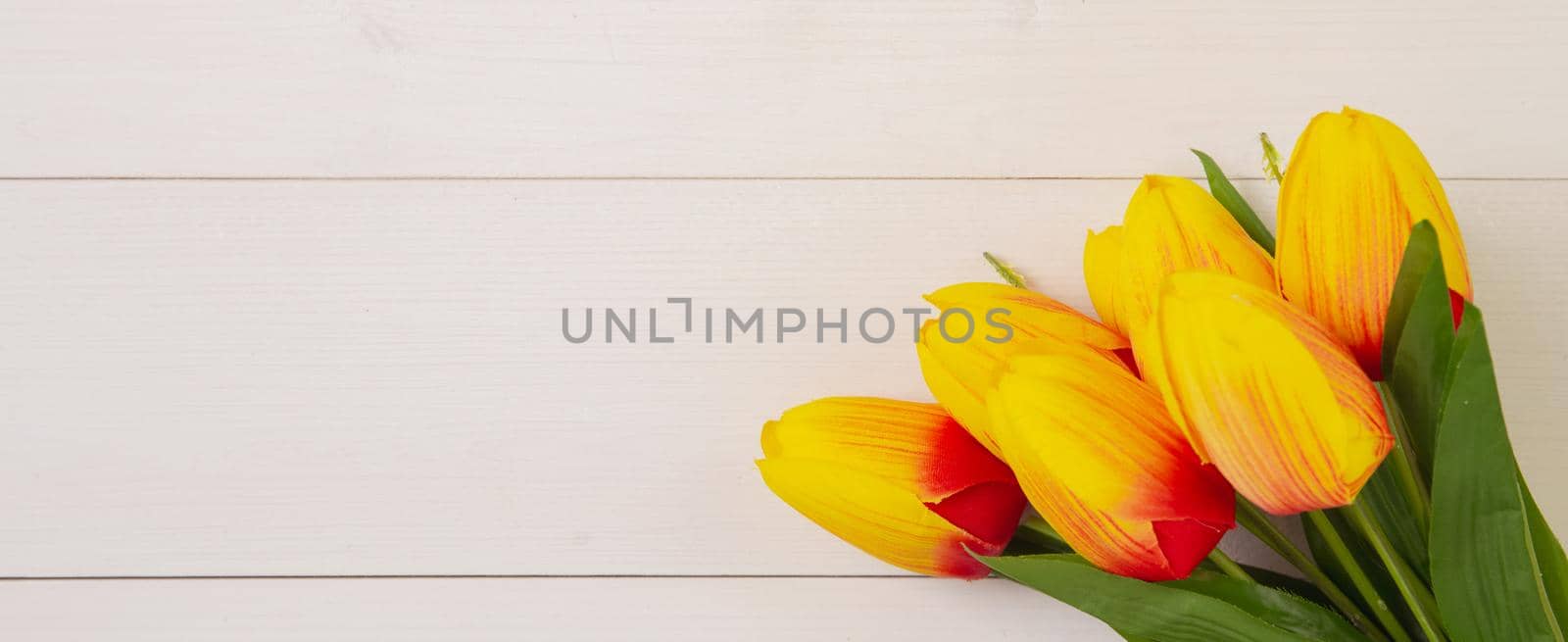 Beautiful tulip flower on wooden background with romantic, mother day or valentine day with pastel tone, nature for decoration, bouquet floral for gift on desk, holiday concept, banner website.