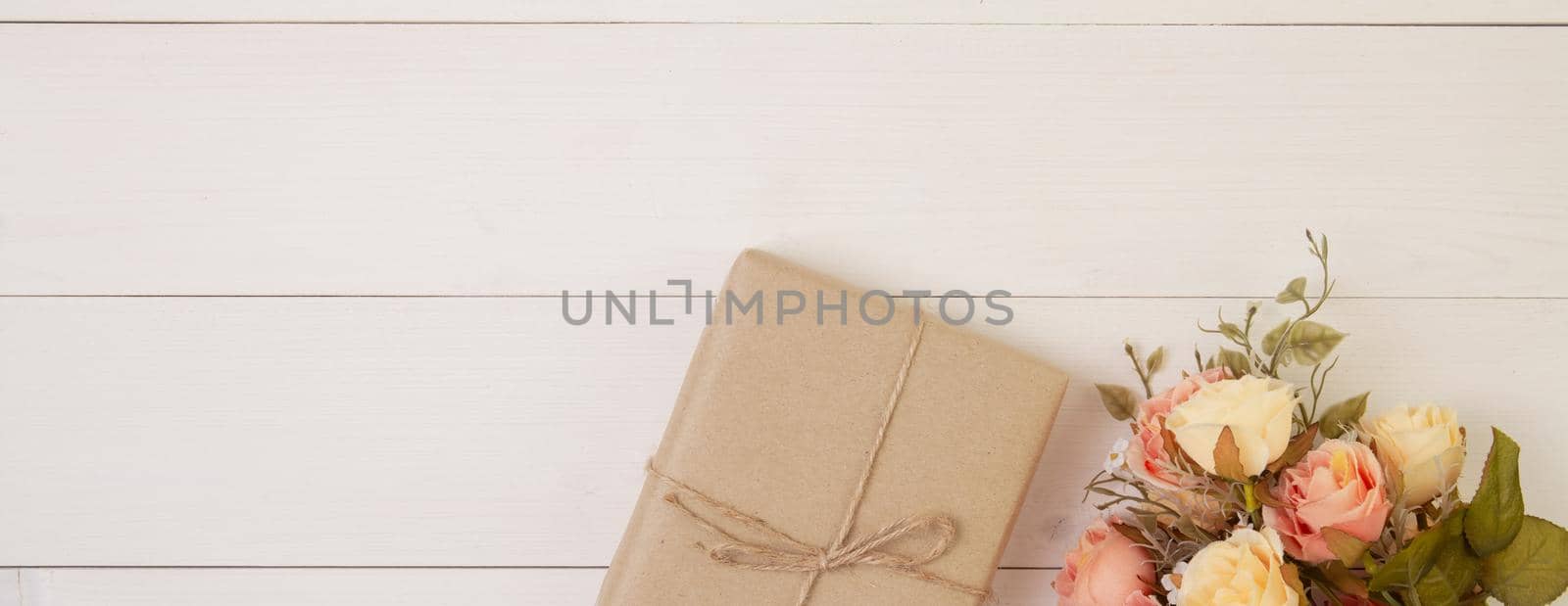 Beautiful flower and gift box on wooden background with romantic, presents for mother day or valentine day with pastel tone, nature for decoration on desk, holiday concept, banner website.