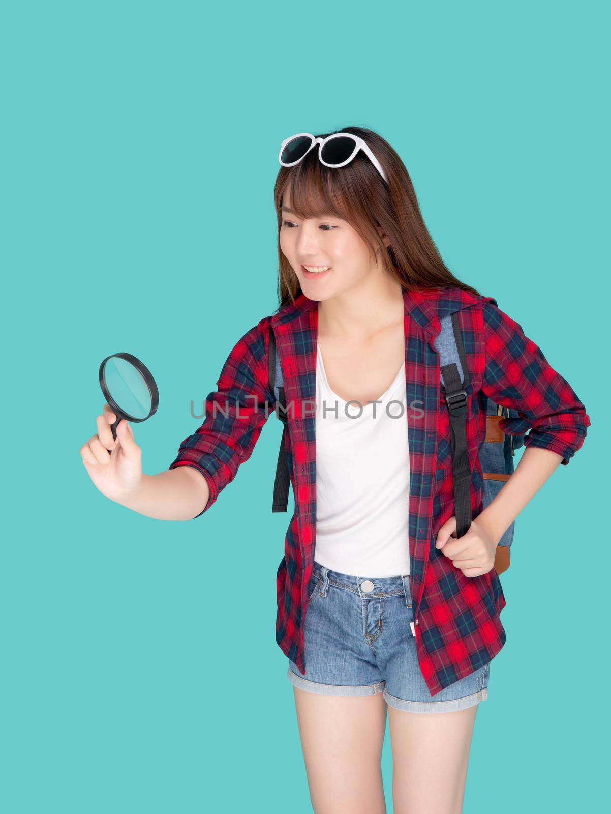Beautiful portrait young asian woman looking something with magnify glass for planning guide to travel summer trip, asia girl search route and location for destination of journey in vacation.