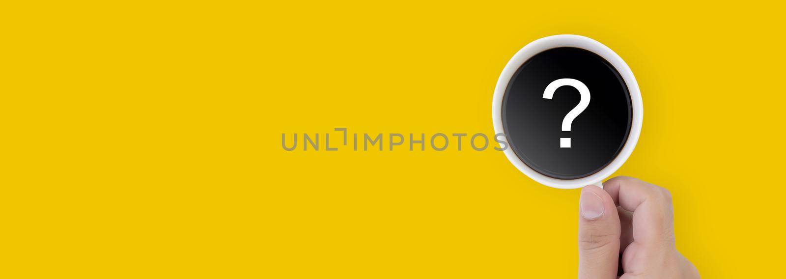 Hand holding cup of hot coffee with question mark isolated on yellow background, top view, q & a, faq or assistance for incentive, beverage or breakfast, communication and idea concept, banner website by nnudoo