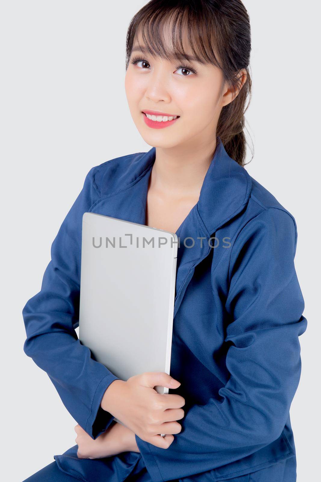 Beautiful portrait young asian business woman holding laptop computer isolated on white background, businesswoman using notebook, asia freelance girl work job surfing internet online or sending email. by nnudoo
