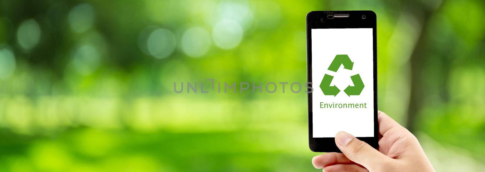 Smart phone holding hand with recycle symbol eco environment Icon concept with green bokeh background, ecology conservation and reuse, reduce using and protection resources in nature, banner website.
