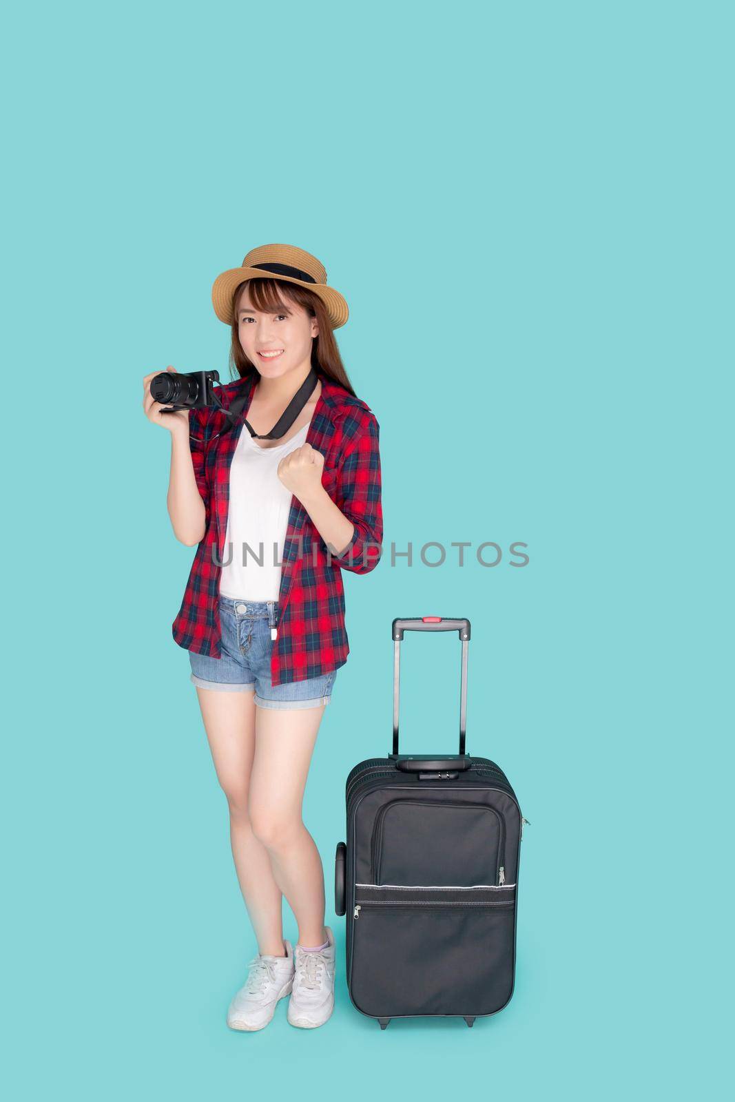 Beautiful young asian woman standing with luggage smiling and travel summer trip for abroad in vacation, asia girl holding camera with suitcase gesture success for journey with cheerful in holiday.
