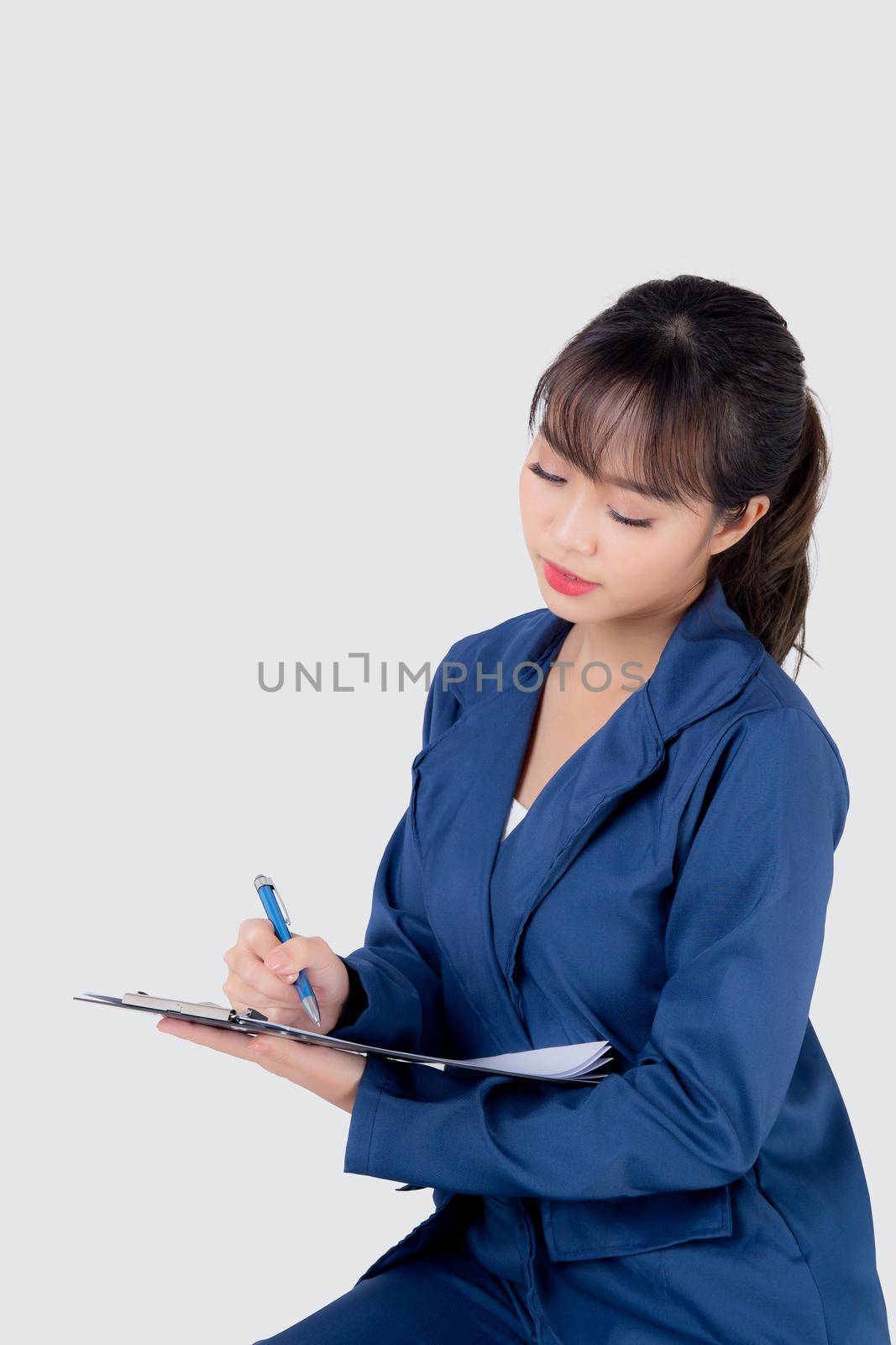 Beautiful portrait young business asian woman thinking and writing on clipboard for success isolated on white background, confident businesswoman planning and idea for inspiration and successful. by nnudoo