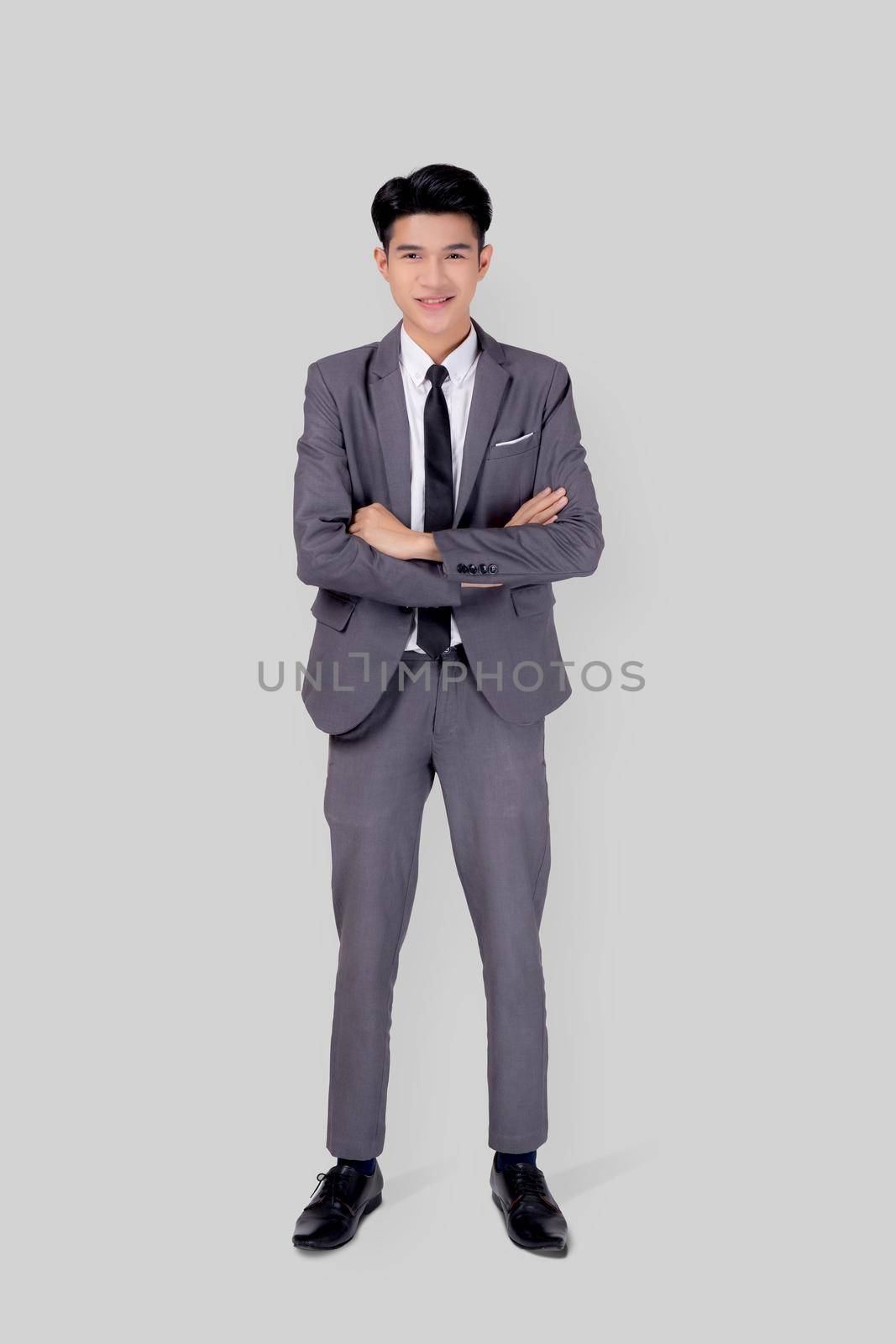 Full length portrait businessman in suit with crossed his arms standing isolated on white background, young asian business man is manager or executive having confident is positive with success. by nnudoo