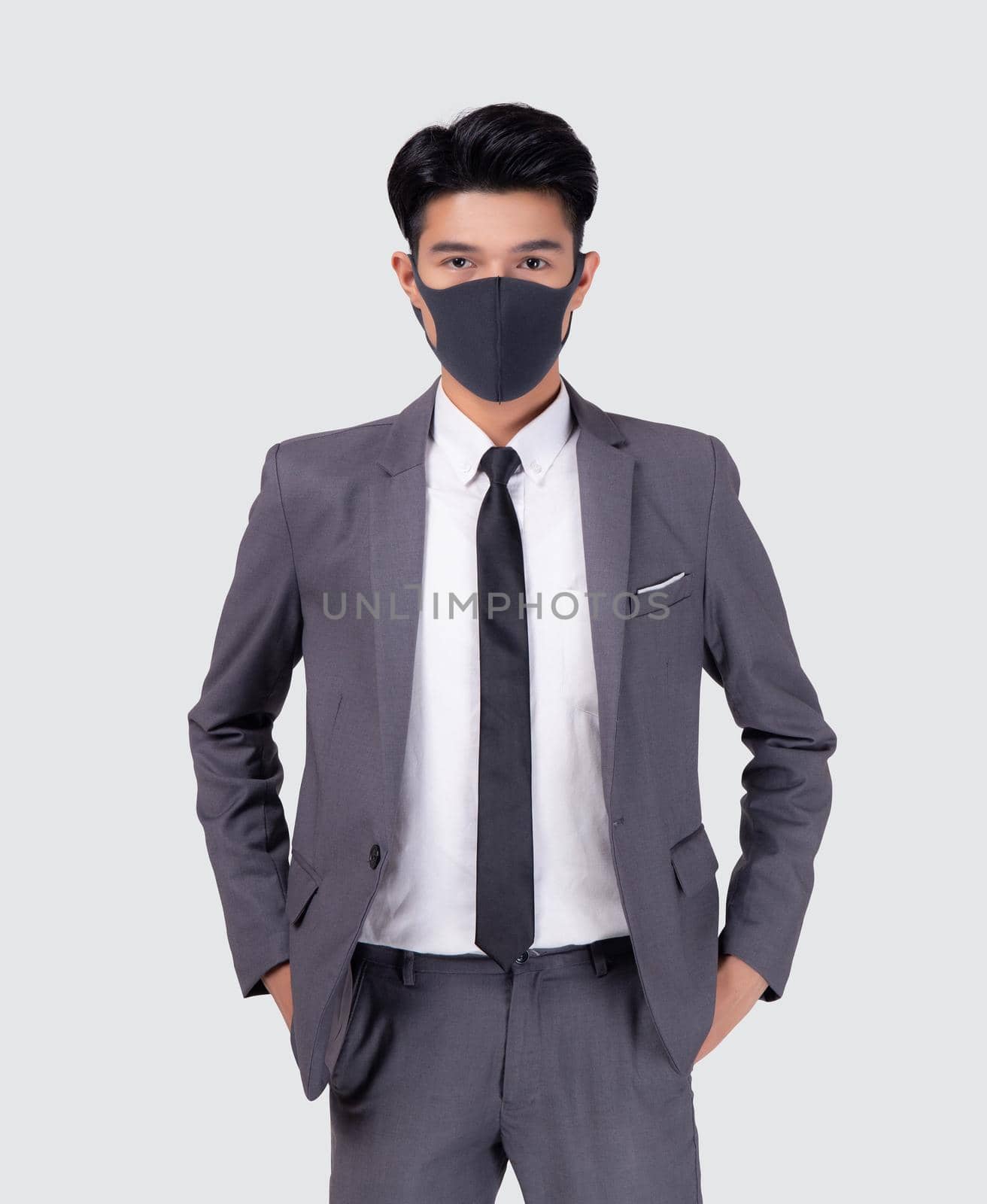 Portrait young asian businessman in suit wearing face mask for protective covid-19 isolated on white background, business man and healthcare, quarantine for pandemic coronavirus, new normal.