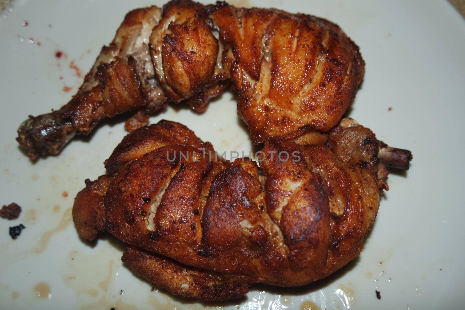 Fried, grilled baked chicken pieces with marinated spices on it. Tasty delicious fried chicken barbecue
