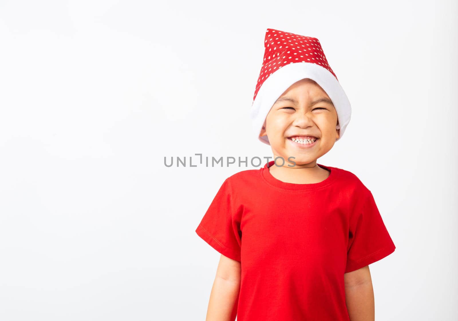 Kid dressed in red Santa Claus hat by Sorapop