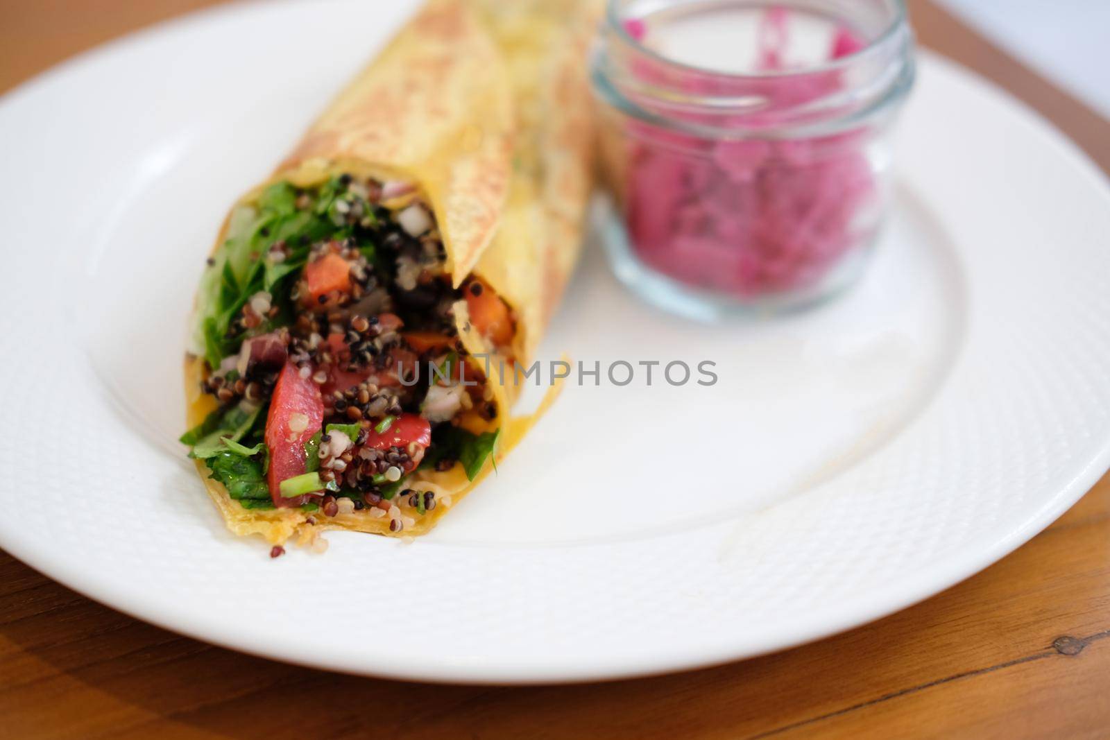 vegan wrap with quinoa, black bean, mango, cashew nut, bell pepper
