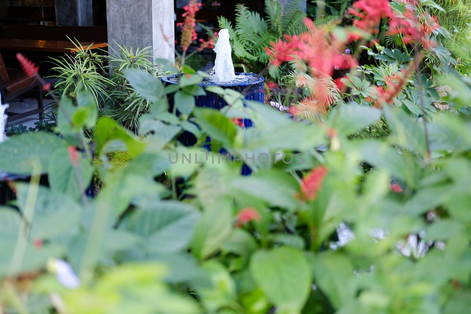 fountain on blue water jar decorating in garden