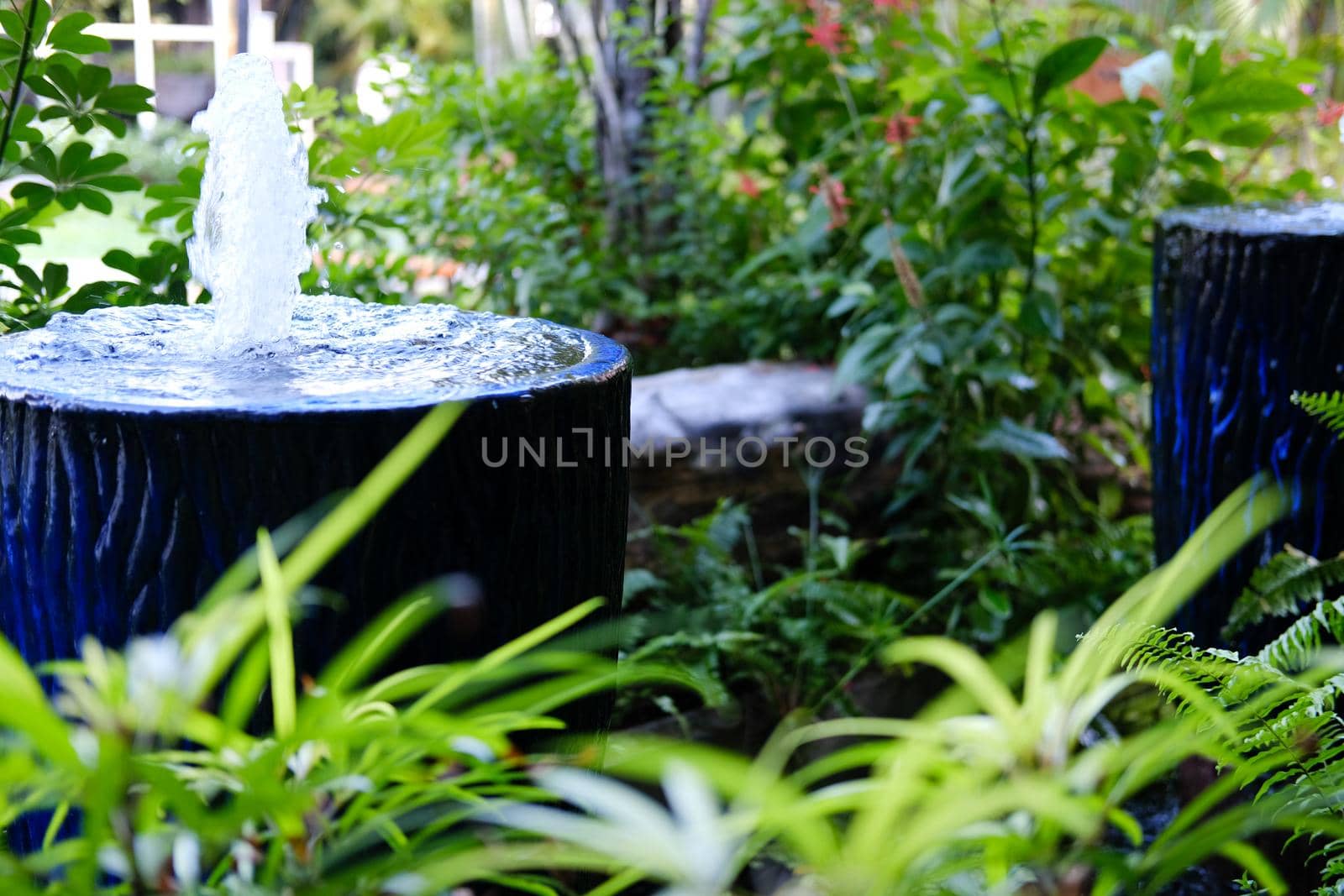 fountain on blue water jar decorating in garden