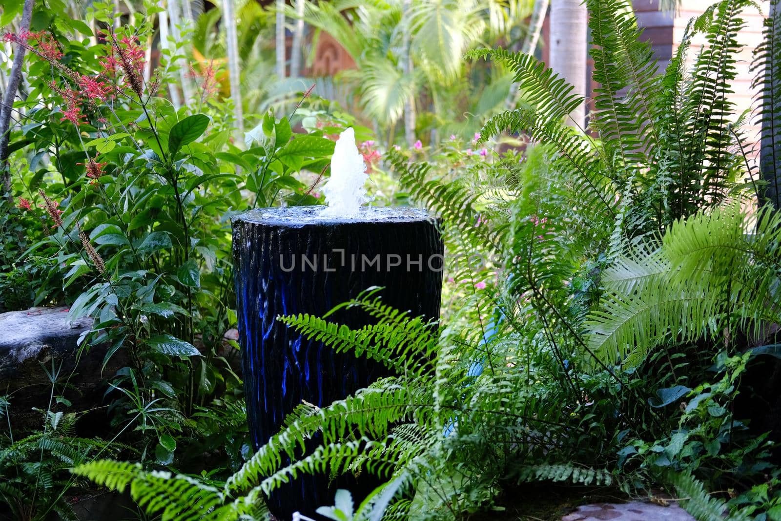 fountain on blue water jar decorating in garden
