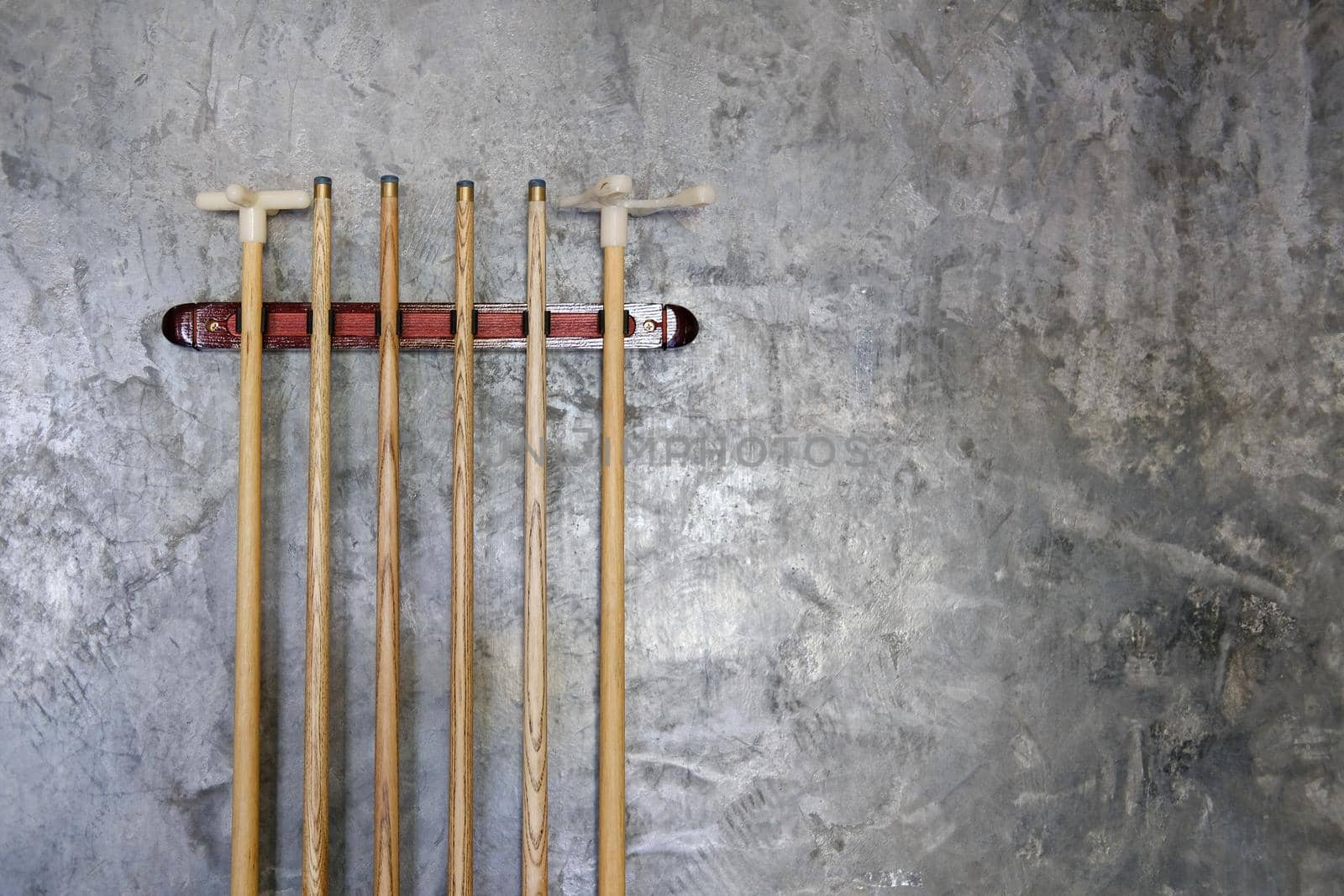 billiard cue sticks hang on wall