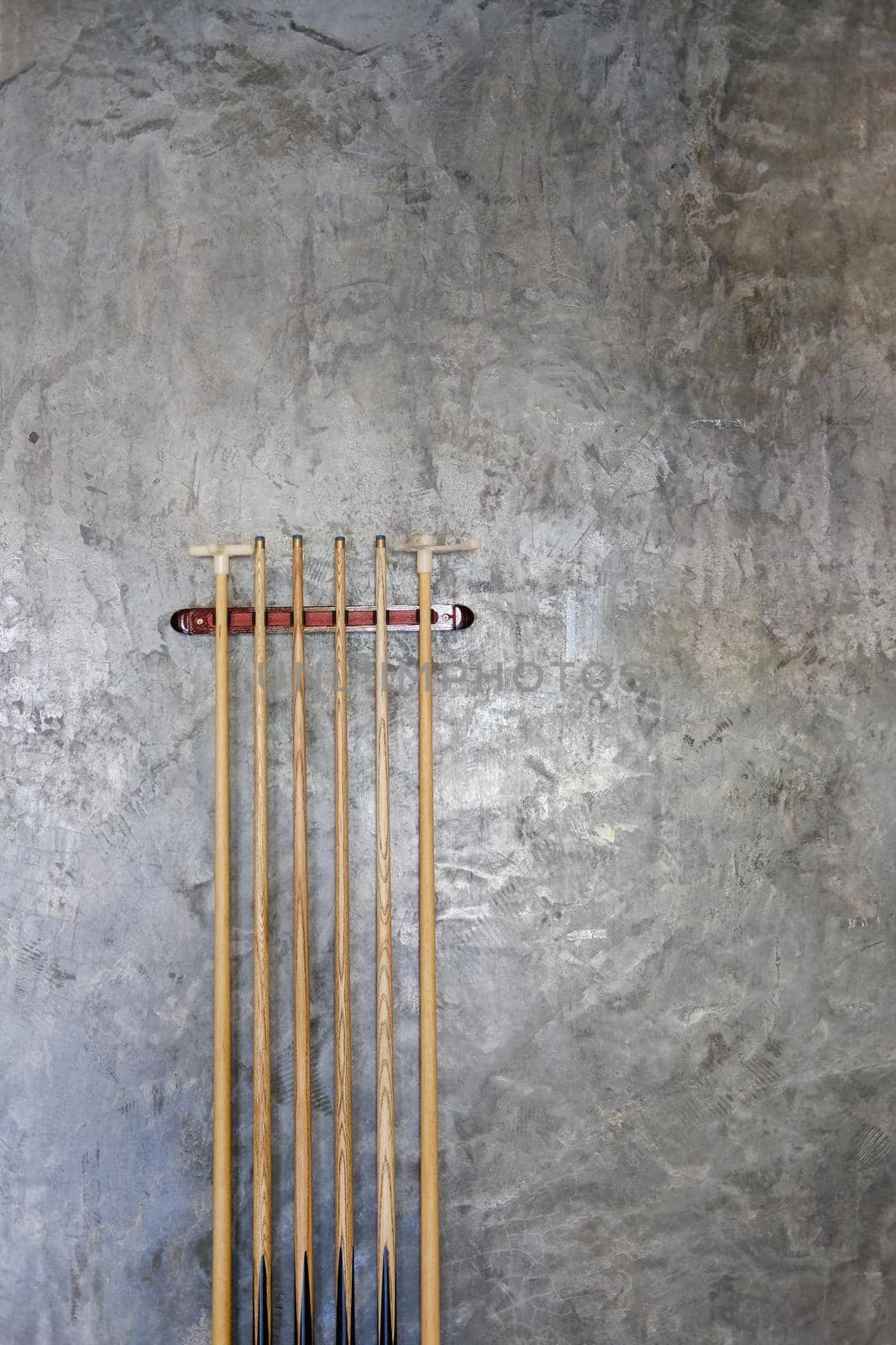 billiard cue sticks hang on wall