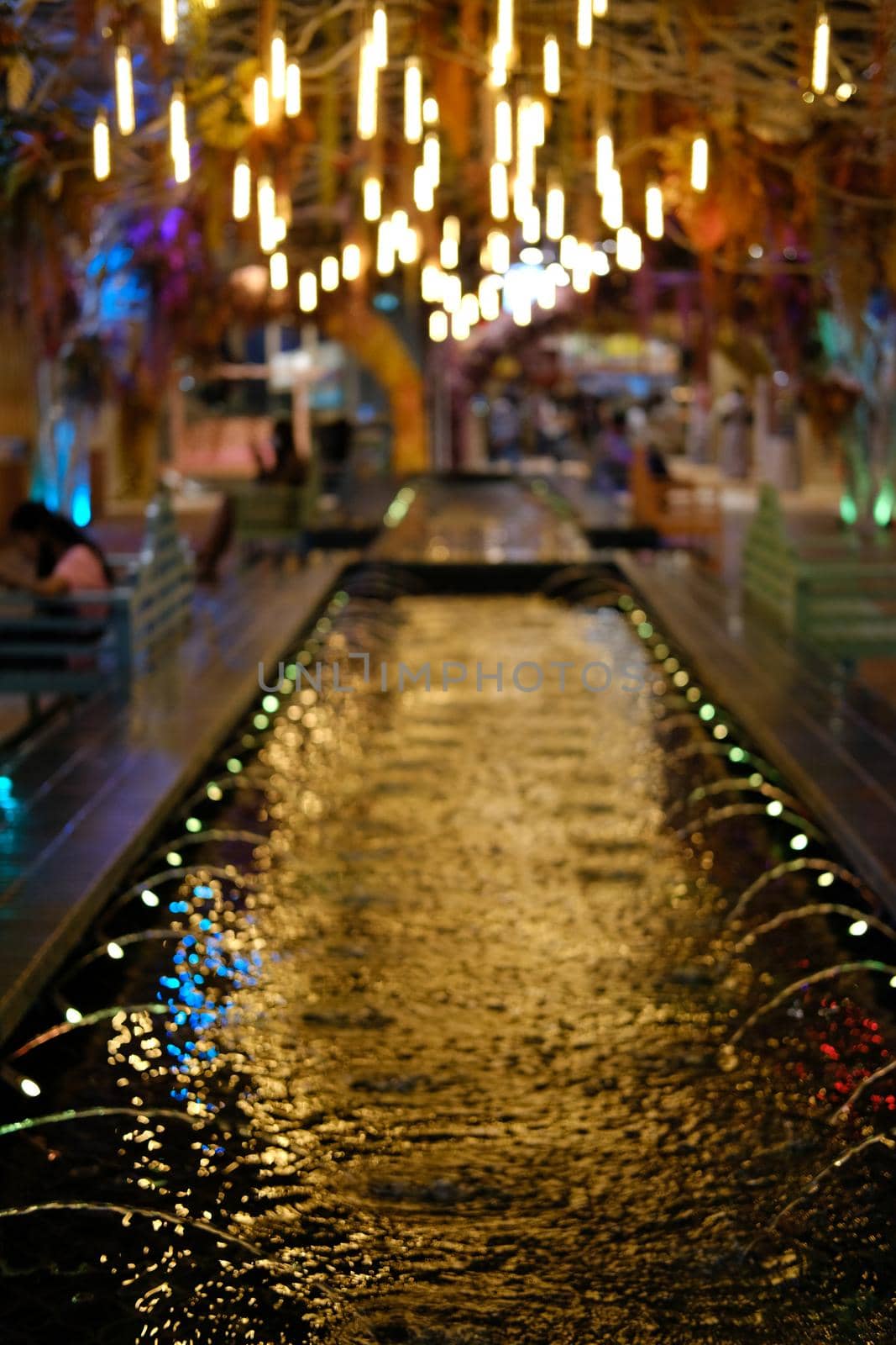 decorative light and fountain on pond abstract background