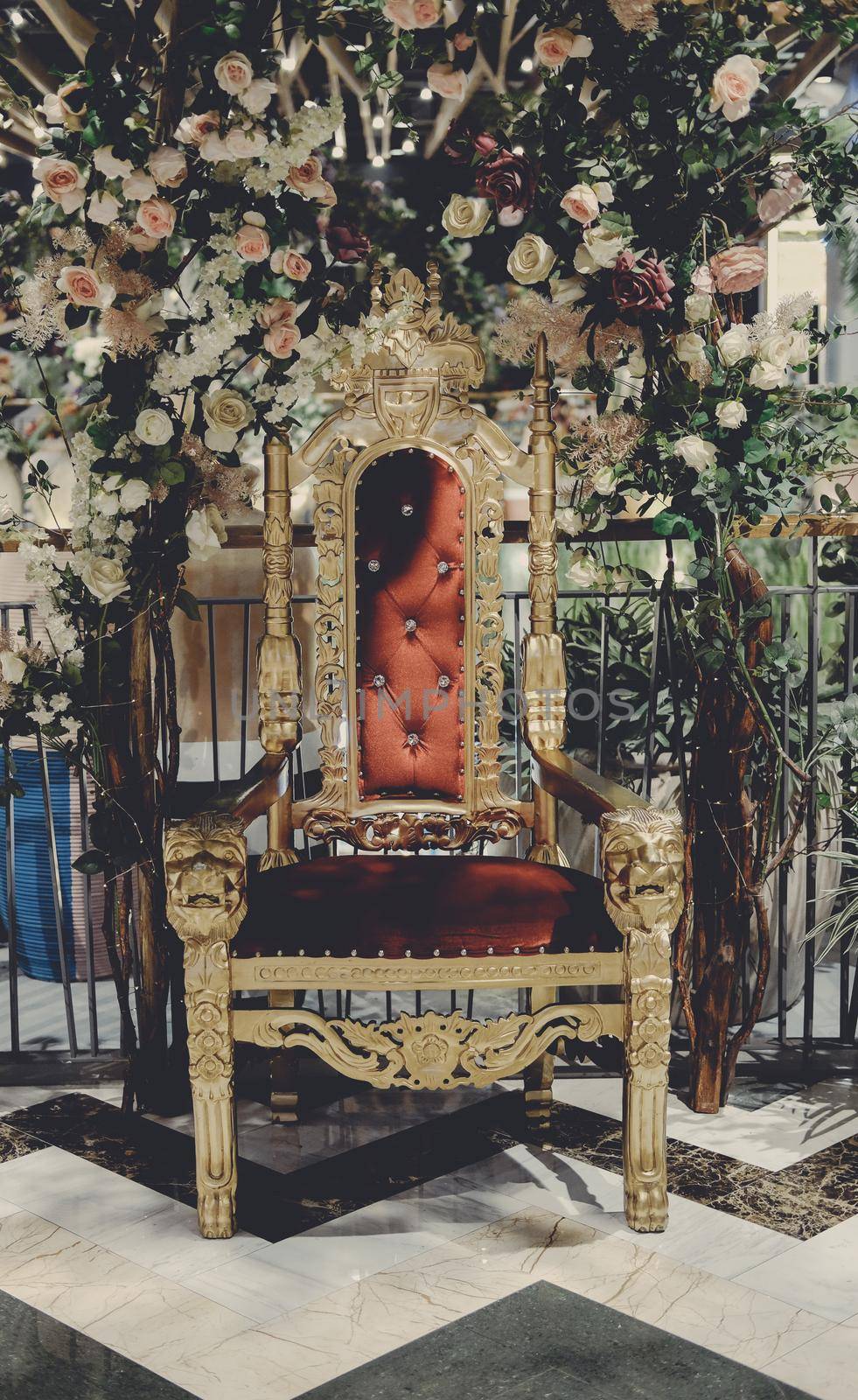 golden chair with red velvet cushion