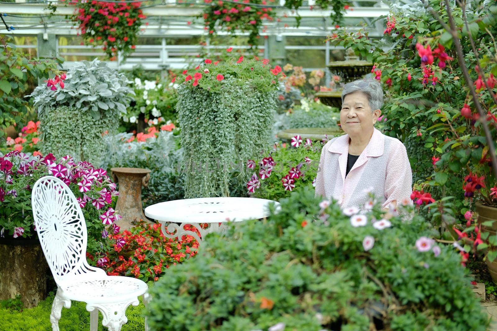 asian old elderly elder woman resting relaxing in garden. senior leisure lifestyle