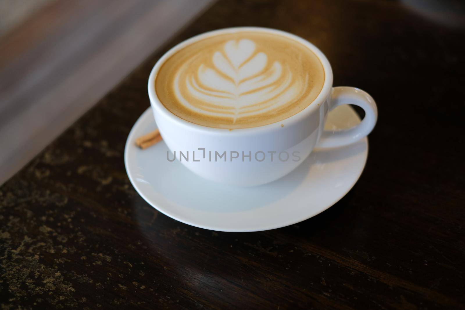 hot cappuccino mocha coffee with latte art and cinnamon.