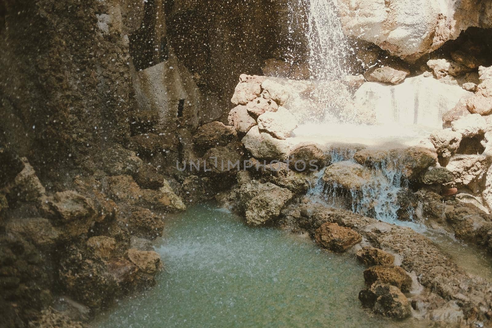 manmade waterfall park. flowing water stream