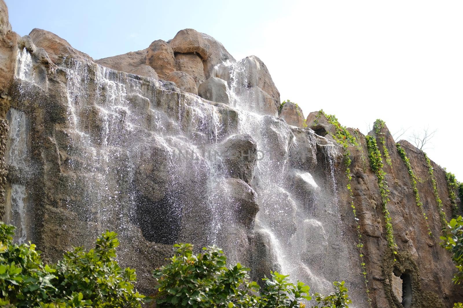 manmade waterfall park. flowing water stream